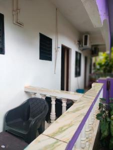 a balcony with a table and a black chair at Shree Stay in Anjuna