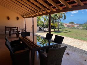 a patio with a table and chairs on a porch at Vipingo Ridge, The Maridi Villa by Diplo El Homes in Pingilikani