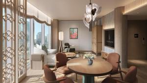 a living room with a table and chairs at Four Seasons Hotel Tokyo at Marunouchi in Tokyo