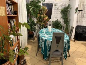 a table with a table cloth on it in a room with plants at Le Nazareth in Lyon +5 photos