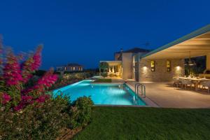 a swimming pool in the backyard of a house at Villa Ianira in Kolymvari