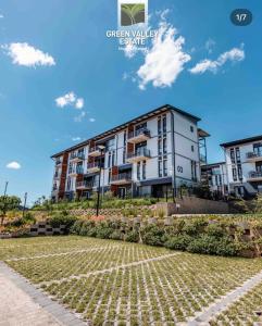 an apartment building in the middle of a park at Grey Heaven Retreat in Boschrand