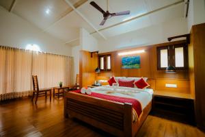 a bedroom with a large bed in a room at Anvitha Mansions in Attigundi