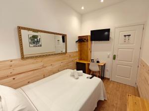 a bedroom with a bed and a mirror and a desk at Hostal Aliste in Madrid