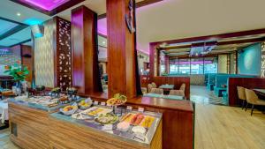 a buffet in a restaurant with food on display at Donatello Hotel in Dubai