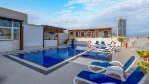 a house with a swimming pool with blue water at Donatello Hotel in Dubai