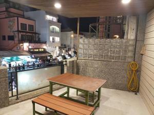 a table and bench on the side of a restaurant at Hai Gang Yuan Homestay in Kenting