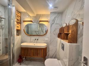 a bathroom with a sink and a mirror at Appartement Le Millie 3 chambres Hyper centre in Calvi +33 photos
