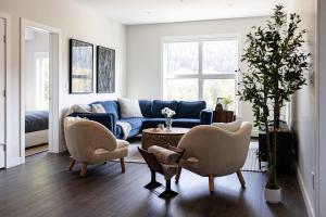a living room with two chairs and a couch at Riverstone Retreat in Golden BC in Golden