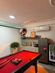 a kitchen with a pool table in a room at De'Lea Homestay & Hotel in Ho Chi Minh City