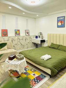 a bedroom with a large bed and a table at De'Lea Homestay & Hotel in Ho Chi Minh City