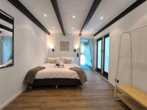 a bedroom with a large bed in a room at Waldnest Eifel in Kerschenbach