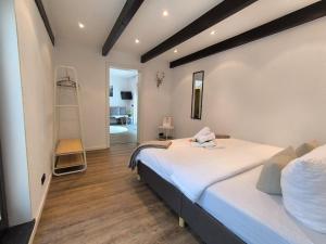 a bedroom with two beds and a ladder at Waldnest Eifel in Kerschenbach