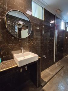 a bathroom with a sink and a mirror at Hotel AL Amin in Kuala Lumpur