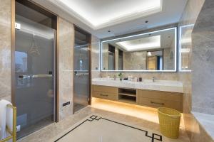 a bathroom with a sink and a mirror at Floral Luxury Hengdian Jiuqilu B&B in Longfengshan +103 photos