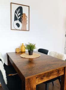 a wooden dining room table with black chairs at Studio au Cœur des Sommets in Crans-Montana +14 photos