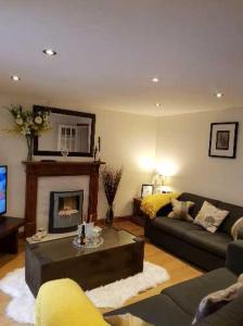 a living room with a couch and a fireplace at The Garden Flat in Windermere +2 photos