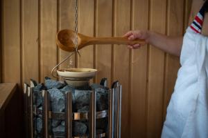 eine Person, die mit einem Holzlöffel eine Schüssel zubereitet in der Unterkunft Casa Oliva Tokaj in Tokaj