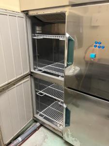 an empty oven with its doors open in a kitchen at 波浮とみや全部屋個室 in Oshima +20 photos