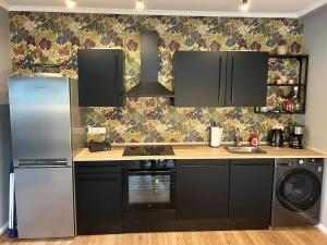 a kitchen with a refrigerator and a sink at Ferienwohnung Hodenhagen in Hodenhagen