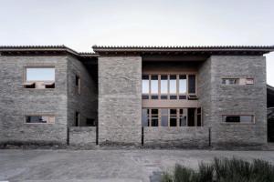 a large brick building with a lot of windows at Dali Ancient City Xishan Designer Hotel in Dali Ancient Town