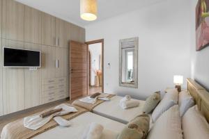 a living room with a large couch and a tv at Panos Apartment Naousa in Naousa +29 photos