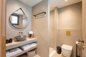 a bathroom with a toilet and a mirror at Naiades Guest House in Sálakos +18 photos
