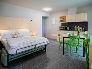a bedroom with a bed and a table and chairs at Il nido di Siro in Cercino