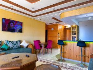 a living room with a couch and a table at Lux'Or Scandinavian-style, pool & play area in Oued Laou