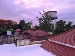 a view of roofs with a water tower in the background at Shakuntal in Shāhāpur