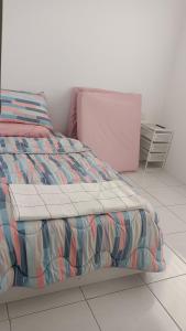 a bedroom with a bed with a colorful comforter at BB Homestay in Tuaran +6 photos