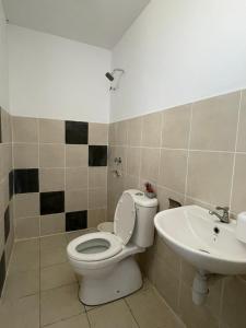 a bathroom with a toilet and a sink at BB Homestay in Tuaran