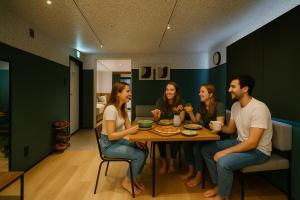 a group of people sitting around a table at R Residence 天下茶屋 IV in Osaka