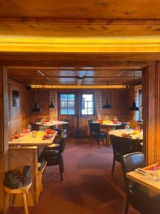 a dining room with tables and chairs in a restaurant at Sonne in Klosters