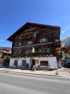 a large wooden building on the side of a street at Sonne in Klosters