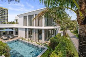 an exterior view of a house with a swimming pool at Aqua Vista Hoi An Beachfront Villas in Dien Ban