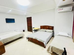a hotel room with two beds and a table at OZ motel in Mechta el Hadj Douibi