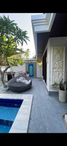 a swimming pool with a tire next to a house at Pranajaya paradise in Tejakula +9 photos