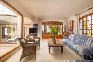 a living room with a blue couch and a table at Es Mollet de Barcares in Alcudia