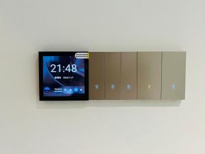 a tv hanging on a wall next to cabinets at Ideal for Nomads BKK1 Studio with Free Cafe &Wi-Fi in Phnom Penh