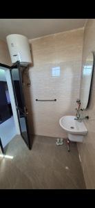 a bathroom with a white sink and a mirror at Thiam APPART in Nouakchott