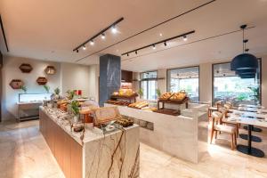 a large kitchen with a counter and a table at Alizo Comfort Chic Stay Rhodes - Adults Only in Ixia
