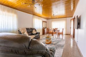 a living room with a couch and a table at A Casa dos Amigos - Termas São Vicente in Penafiel