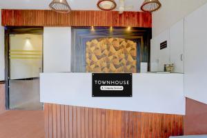 a room with a counter with a sign on it at Townhouse Andheri Sakinaka Metro Formerly Hotel Amour in Mumbai