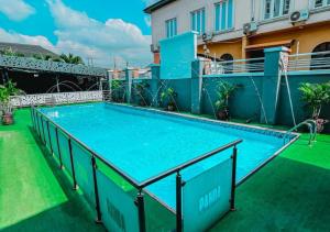 a large swimming pool on the roof of a building at Aotel Hotels & Suites - Ojota in Lagos