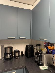 a kitchen counter with many pots and pans on it at Meri 2 in Ostermundigen +2 photos