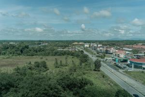 an aerial view of a city with a road and buildings at SUMMER SUITES APARTMENT CASETTA HOMESTAY 3A at Kota Samarahan Kuching in Kuching