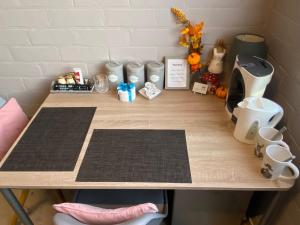 a wooden table with two mats on top of it at Toezens in Ingelmunster