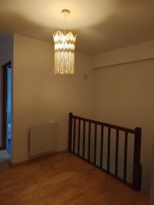 a chandelier hanging from the ceiling in a room at Maisonnette proche de Strasbourg in Vendenheim +5 photos