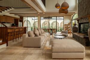a living room with a couch and a table at Tuluscoliving Villa Kuta 1, 4 Bedroom & 5 Bathroom in Ngurah Rai International Airport